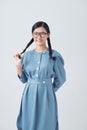 Charming girl holding haired braids in hands, happy playfully looking camera isolated on a white background