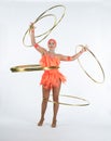 A charming girl performs circus elements with a hula Hoop