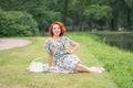 Charming girl with red hair in retro style posing in a vintage dress Royalty Free Stock Photo