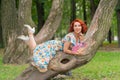 Charming girl with red hair in retro style posing in a vintage dress Royalty Free Stock Photo