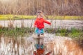 Charming girl running in big puddle Royalty Free Stock Photo