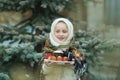 Charming girl in Russian chalet holding a plate with Easter eggs