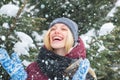 Charming girl wearing warm winter clothes. Outdoor close up portrait of beautiful smiling blonde woman with red nose Royalty Free Stock Photo