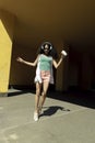 Charming girl in wireless headphones enjoying music and jumping in the air Royalty Free Stock Photo