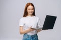 Charming happy young business woman or student holding laptop computer and looking away. Royalty Free Stock Photo