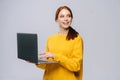 Charming happy young business woman or student holding laptop computer and looking away. Royalty Free Stock Photo