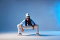 Charming hip hop dancer in cap Royalty Free Stock Photo