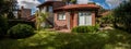 Charming home with red bricks cozy house and front garden at a residential neighborhood Royalty Free Stock Photo