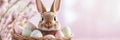 This Easter scene features a cute bunny among colorful eggs in a woven basket, surrounded by soft pastel colors that Royalty Free Stock Photo