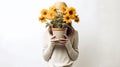 Charming image of a girl holding a pot of flowers against a white background.