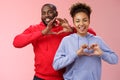 Charming joyful caring young african american family man woman siblings smiling broadly show heart gestures grinning