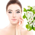 Charming lady with with blooming spring apple tree branches, beautiful young caucasian woman over white background