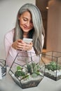 Beautiful joyful woman using mobile phone at home Royalty Free Stock Photo