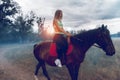 Charming lady with massaging jets in sportswear on a horse Royalty Free Stock Photo