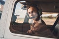 Attractive young woman sitting inside airplane cockpit Royalty Free Stock Photo