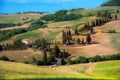 Charming landscape with a car on a curved road with many twists in Tuscany, Italy near Pienza. Excellent tourist places