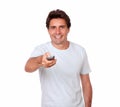 Charming latin man holding remote control Royalty Free Stock Photo