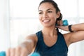 Charming Latin woman working out with dumbbells in gym Royalty Free Stock Photo