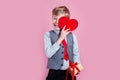 Charming little boy posing with heart on pink background Royalty Free Stock Photo