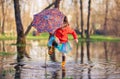 Girl splashing dirty puddle with fun Royalty Free Stock Photo