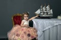 charming little girl in elegant white with a pink dress sitting Royalty Free Stock Photo