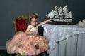 charming little girl in elegant white with a pink dress sitting Royalty Free Stock Photo