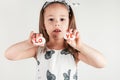 Charming little girl hold decorative stone halves with letters LOVE. Portrait of child on white. Creative craft.