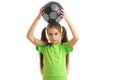 Charming little girl holding a soccer ball on her head Royalty Free Stock Photo