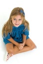 Charming little girl sitting on floor in studio Royalty Free Stock Photo