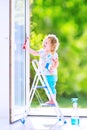 Charming little girl washing a window Royalty Free Stock Photo