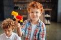 Charming little kid posing with car toy for camera Royalty Free Stock Photo