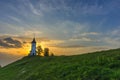 Charming little St. Primus and Felician church in Jamnik, Julian Alps, Slovenia and beautiful sunrise sky colors Royalty Free Stock Photo