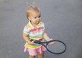 Charming little tennis player with a racket