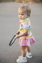 Charming little tennis player with a racket