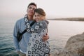 Charming long-haired girl posing with her stylish boyfriend in trendy hat, gently touching his shoulder. Portrait of Royalty Free Stock Photo