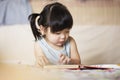 Charming and lovely asian kid concentrated on reading book