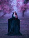 Charming maiden in a blue brakhatny cloak in a wide belt, with pink hair in the forest as a sacrifice for the devil. the