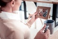 Charming mature woman holding wooden photo frame with her family picture Royalty Free Stock Photo