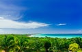 Charming mesmerizing view on tropical palm trees garden with tranquil turquoise inviting ocean and beach against blue sky backgro Royalty Free Stock Photo