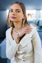 Charming model girl with gold diamond accessories on her body. Lady, with a beautiful soft skin face, looks into camera Royalty Free Stock Photo