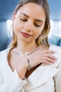 Charming model girl with gold diamond accessories on her body. Lady, with a beautiful soft skin face, looks into camera Royalty Free Stock Photo