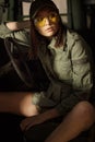 Charming model sitting in the army tank. Royalty Free Stock Photo