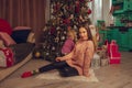 Charming mother and daughter at the christmas tree