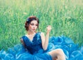 Charming mysterious story about porcelain doll, lovely girl in long blue lush delicate dress. lady with dark braided Royalty Free Stock Photo