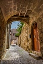 Charming narrow street in the old town of Rhodes, Greece Royalty Free Stock Photo