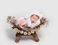 Newborn baby asleep on belly curled up on crib