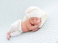 Charming newborn with pillow under head