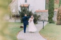 Charming newlywed couple at wedding day dance on green park paved road Royalty Free Stock Photo