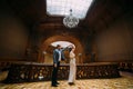 Charming newlywed pair dancing at the background of vintage victorian mansion royal wooden interior Royalty Free Stock Photo