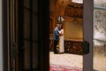 Charming newlywed pair embracing at the background of vintage victorian mansion hall interior Royalty Free Stock Photo